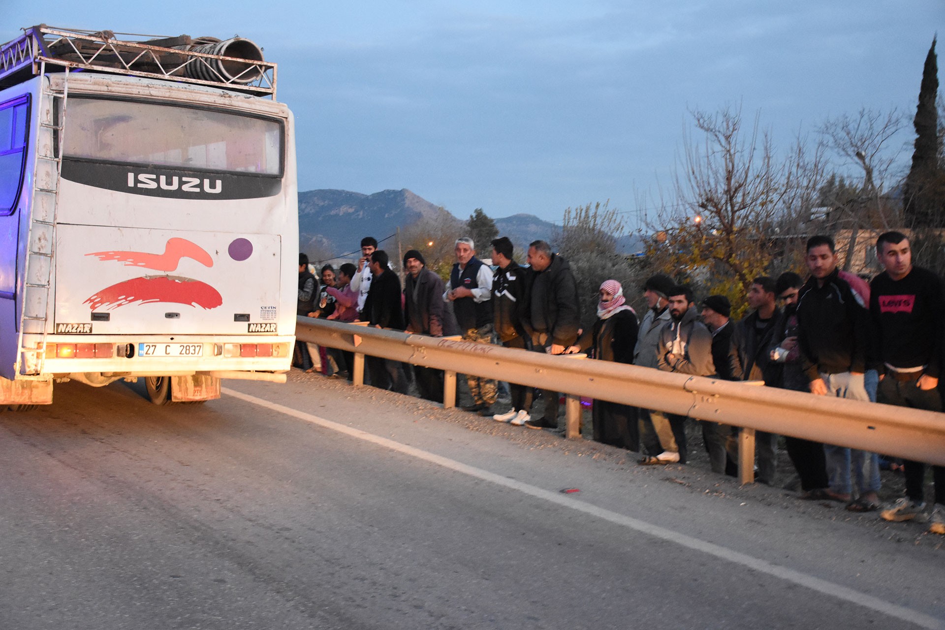 Devrilmiş işçi servisi etrafında ssağlık ekipleri ve polisler çalışma yürütüyor.